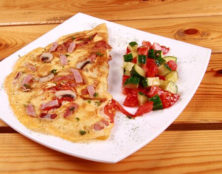 Omelet with prosciutto ham and rocket salad.の写真素材