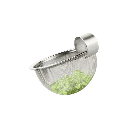 Tea strainer loaded with green teaの写真素材