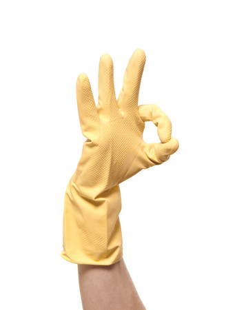 hands in yellow gloves isolated on whiteの写真素材