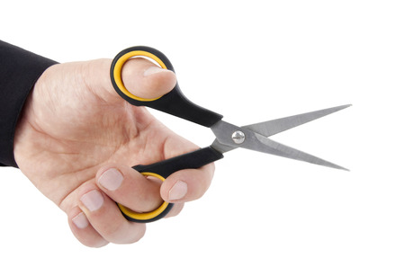 Scissors in hand isolatedの写真素材