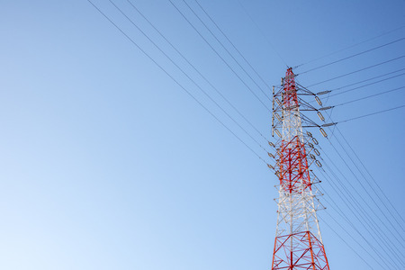 Red and white wired Electric cable Telecom post with blue sky background, technology conceptの写真素材