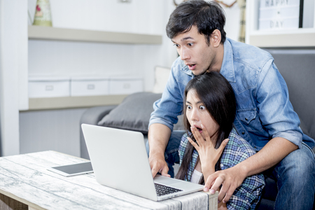Lover are surprising when using the laptop. Family concept, Lovers concept, Technology conceptの写真素材