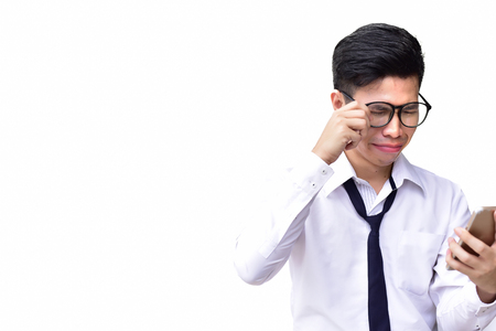 Business man wearing eyes glasses crying when using cell phone on isolated white backgroundの写真素材