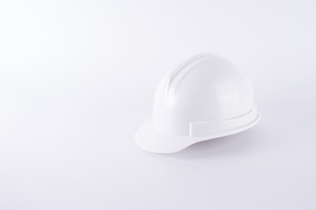 White safety helmet on white background. Hard hat and thick gloves on white isolated background. Safety equipment concept. Worker and Industrial theme.の写真素材