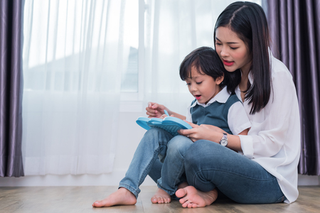Asian mom teaching cute boy to drawing in chalkboard together. Back to school and Education concept. Family and Home sweet home theme. Preschool kids theme.の写真素材