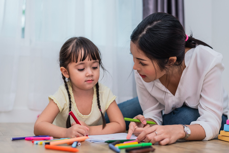 Mom teaching her daughter to drawing in art class. Back to school and Education concept. Children and kids theme. Home sweet home theme.の写真素材