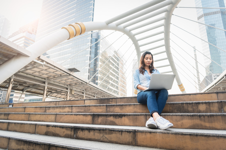 Happy woman working with laptop.  Successful and Happiness concept. Technology and Lifestyle concept City and urban theme. Happy life at Outdoors themeの写真素材