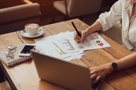 Close up of business woman working with documents and laptop in office. Business and Lifestyles concept. Entrepreneur and Freelance theme.の写真素材