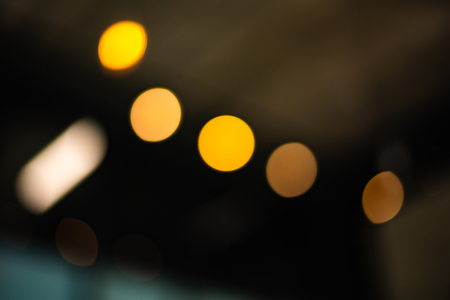 Blurry background of city light in the nightlife. Abstract and wallpaper concept. Traffic and Metropolis theme. Defocused photoの写真素材