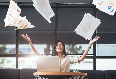 Asian beauty businesswoman throwing paperwork into the air. Successful and achievement concept. Business and Occupation concept. Freelance and business owner theme.の写真素材