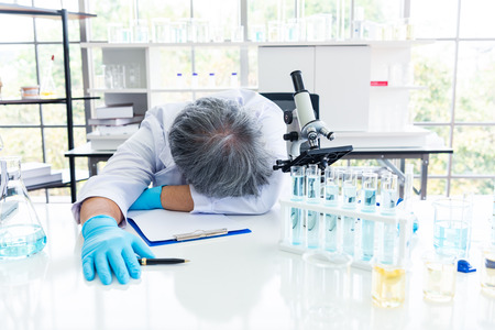 Exhausted scientist sleeping in laboratory. People lifestyles and occupation concept. Science and...