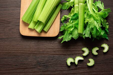 Top view of bunch of fresh sliced celery stalk on wooden table with leaves. Food and ingredients  of healthy vegetable. Freshness herbal and low calories for dieting with plenty of vitaminの写真素材