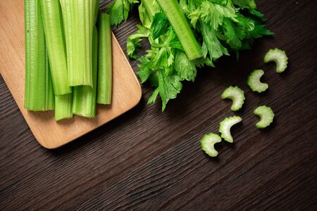 Top view of bunch of fresh sliced celery stalk on wooden table with leaves. Food and ingredients  of healthy vegetable. Freshness herbal and low calories for dieting with plenty of vitaminの写真素材