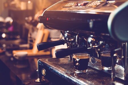 Espresso coffee maker machine working in pub and restaurant bar background. Business food and drinks concept.の写真素材