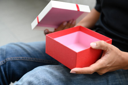 Man opening empty gift box.
