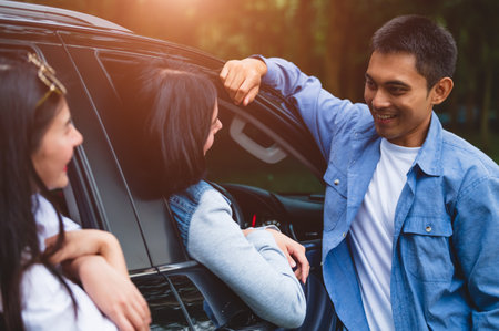 Asian man flirting women in car during travel in forest. Boy talking to girls for meeting. People...