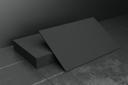Black horizontal business card paper mockup template with blank space cover for insert company logo or personal identity on black concrete floor background. Modern concept. 3D illustration renderの写真素材