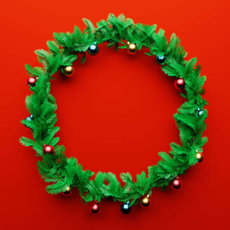 Christmas garland pine decoration with empty space in the middle on red background. Xmas holiday culture and new year concept. 3D illustration renderingの写真素材
