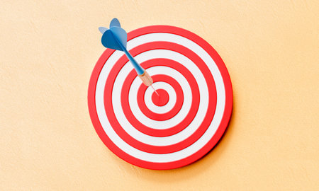Dartboard and dart on center of target on yellow background. Business success and strategy concept. 3D illustration renderingの写真素材