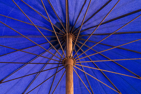 Under a long-handled blue umbrella nylon .の写真素材
