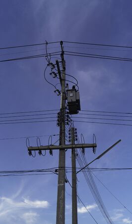 Electricity post and many cable on blue sky background .の写真素材