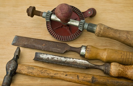 Old woodwork and carpentry tools on wooden tabletop.