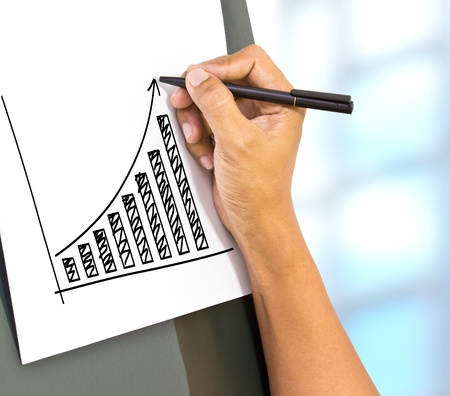 Business hand drawing a rising arrow, representing business growth 