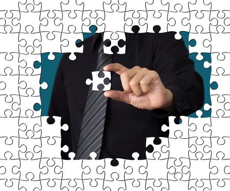 Business concept: Hand holding one pieces of a puzzle