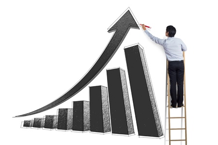 business man standing on ladder drawing growth chart on wallの写真素材
