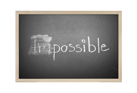 Changing impossible into possible on a chalkboardの写真素材