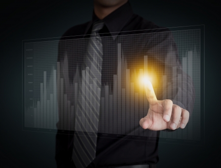 Business man hand pressing a growth chartの写真素材