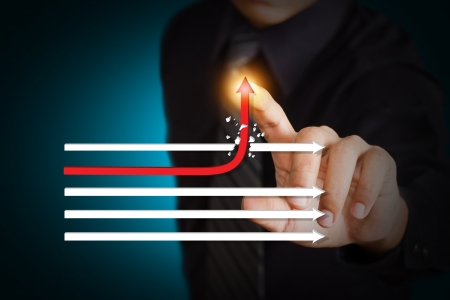 Businessman touching a rising arrow, representing business growth の写真素材
