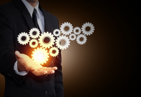 Business man hand show gear to teamwork as conceptの写真素材