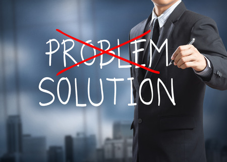 Businessman drawing and crossing out problem and finding the solutionの写真素材