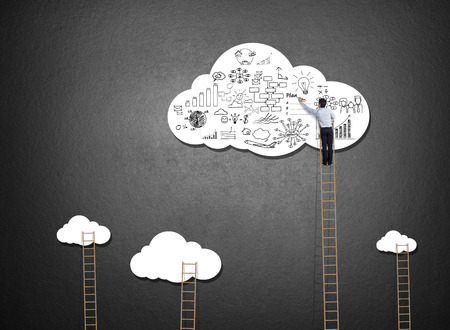 Businessman climbing ladder drawing idea on cloudの写真素材