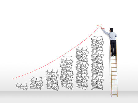 Business man on ladder drawing idea is money concept on wallの写真素材
