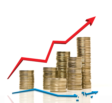 Coin stacks are arraged with growing up red graph and broken blue line graphの写真素材