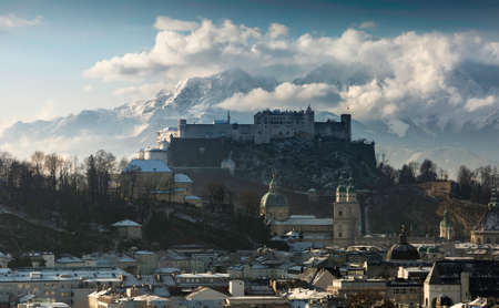 Salzburg castle with snowy mountain backgroundの写真素材
