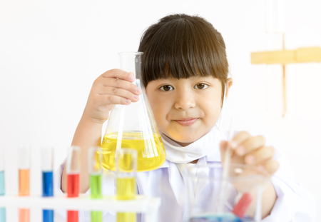 Asian child playing scientist with colorful lab tubesの写真素材