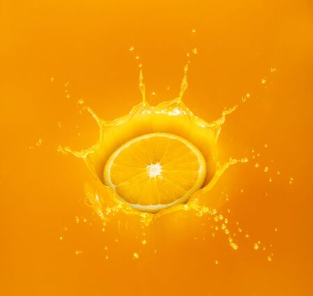 orange drop in splashing orange juiceの写真素材