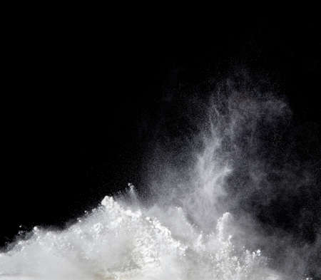powder splash on black backgroundの写真素材