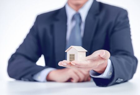 businessman showing home on handの写真素材