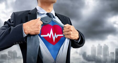 businessman in superhero costume with heartbeatの写真素材