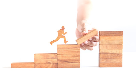 wooden man run across cliff, business challengeの写真素材