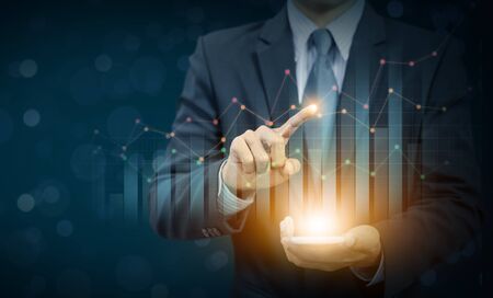 Businessman present growing graph on hand, successful businessの写真素材