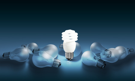 Glowing bright light bulb among others, different and leadership conceptの写真素材