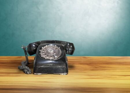 old classic vintage dial telephone on wooden table, communicationの写真素材