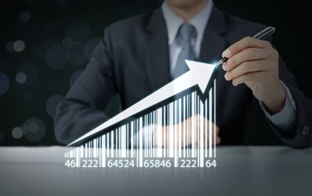 Businessman draw increasing graph with barcode, business growthの写真素材