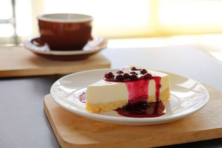 coffee cup with blueberry chesse pie on wooden plate, coffee breakの写真素材