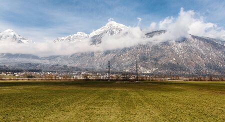 snowy mountain peak with village in autumn and spring, Europe travel destinationの写真素材